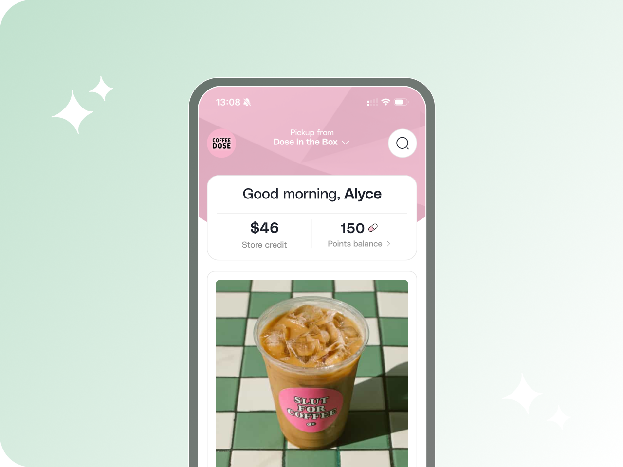 Mobile app screen greeting user Alyce with $46 store credit and 150 points, showing an iced coffee with a pink sticker saying 'SLUT FOR COFFEE' on a green and white tiled table.