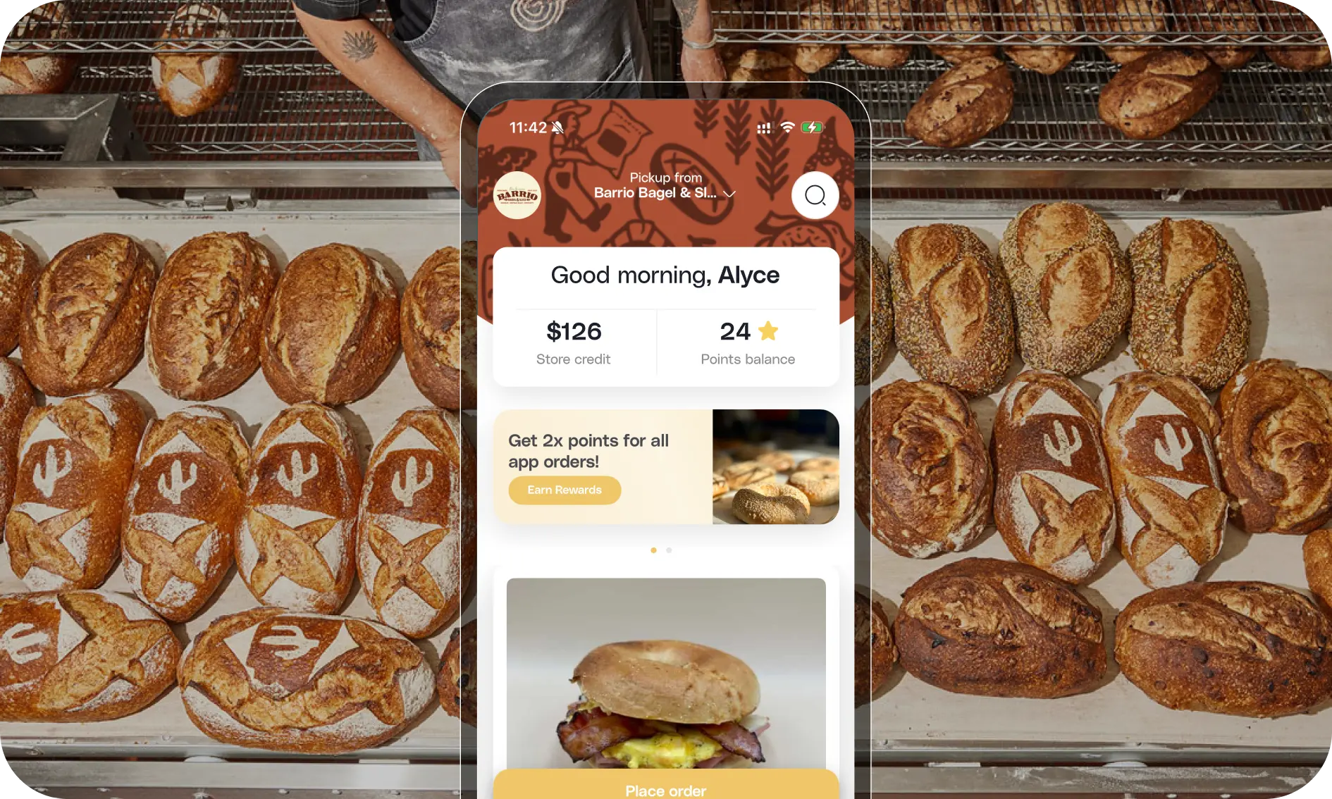 Per Diem app shown over a tray of fresh bagels at Barrio Bagel and Slice.