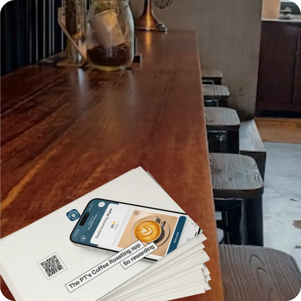 Branded postcards laid out on a wooden surface.