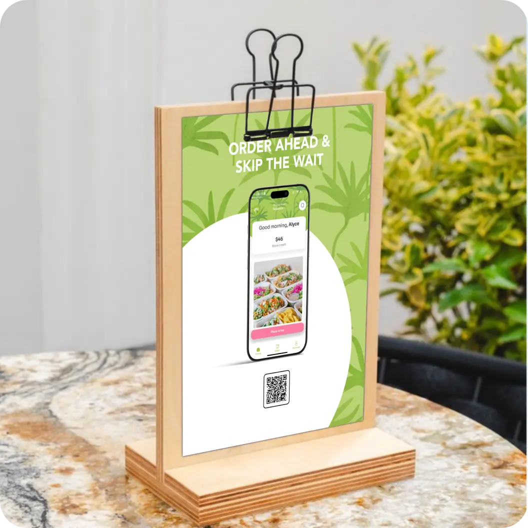 Table tent showing a QR code linking to a branded mobile app.